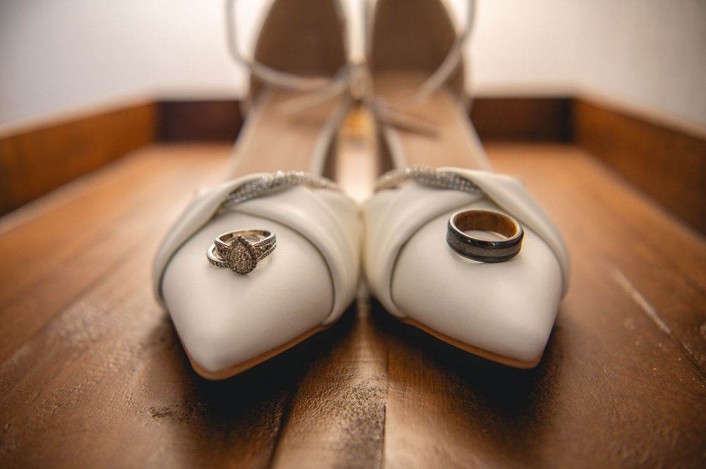 Close-up view of white ceramic heart decorations arranged on a wooden surface in warm lighting.