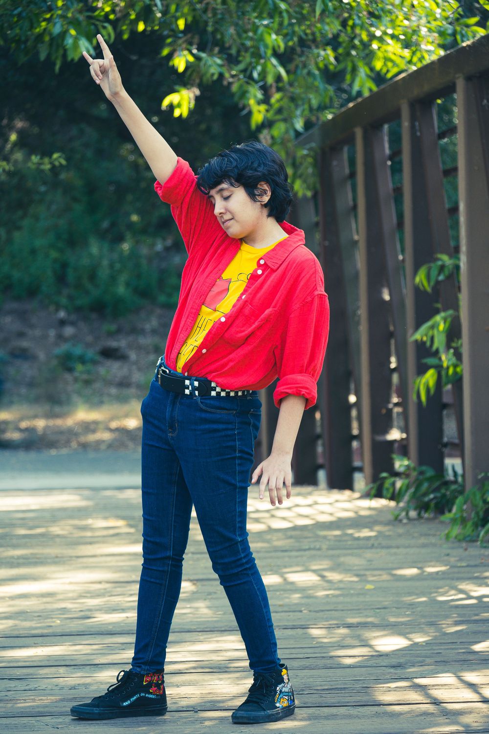 A series of dance poses in red shirt and blue jeans showing graceful stretching movements in a sunlit outdoor setting.