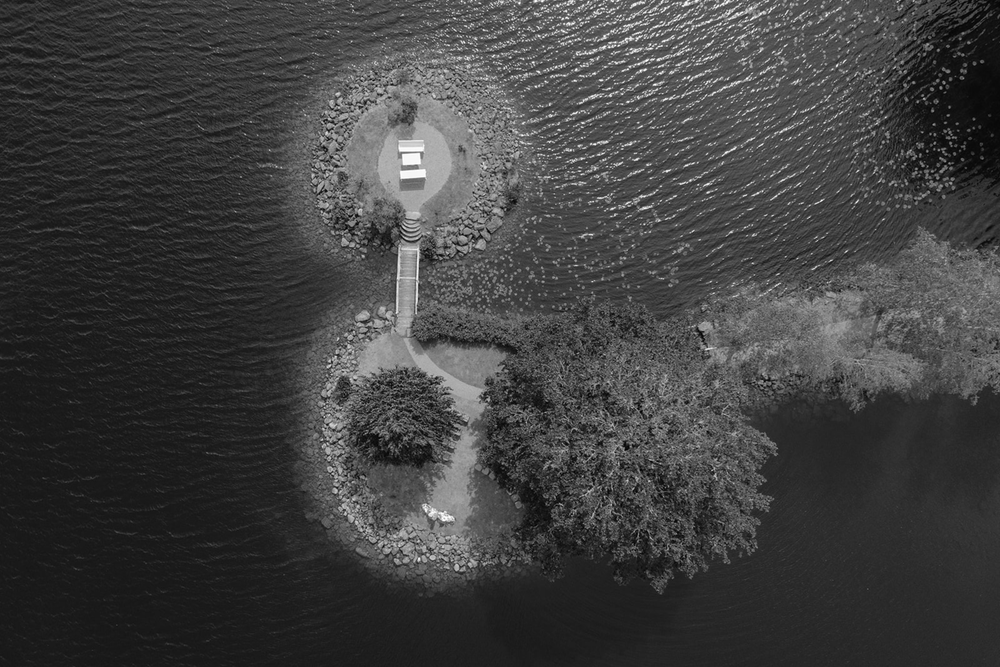 A sequence of black and white images showing a lighthouse at night with its beam sweeping across a dark sky.