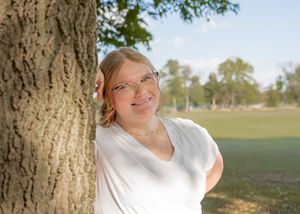 Series of outdoor portrait shots taken near a large tree in a park setting.