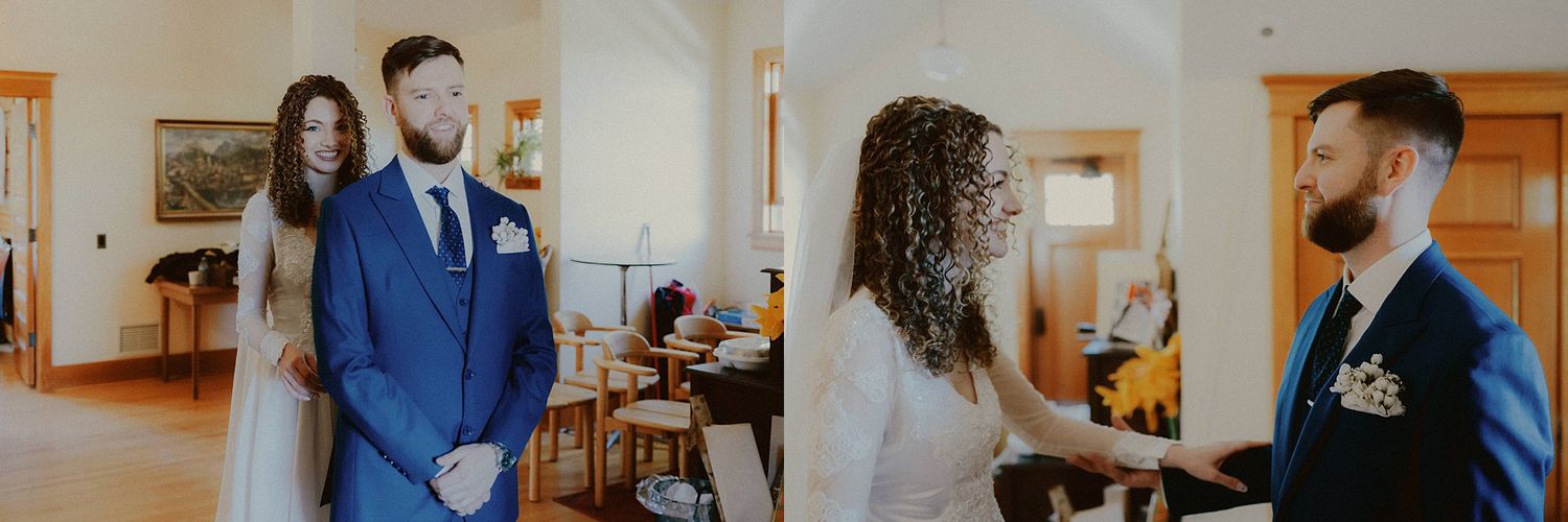 A couple shares their first look moment in a warmly lit interior space.
