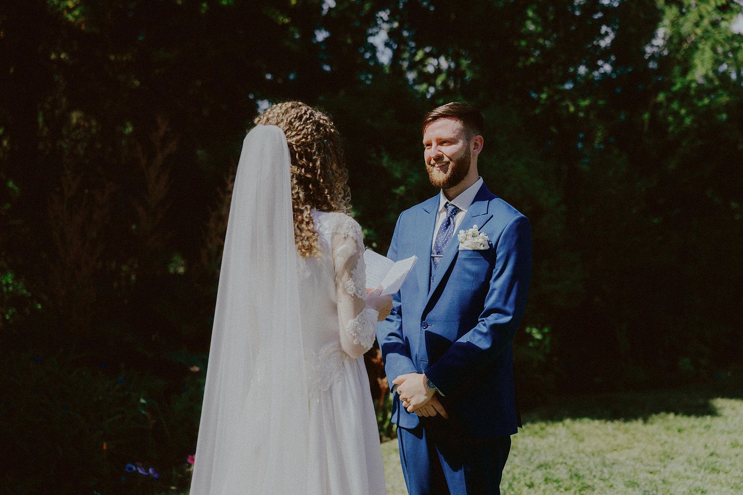 Wedding ceremony in a garden setting with natural greenery and outdoor decor.