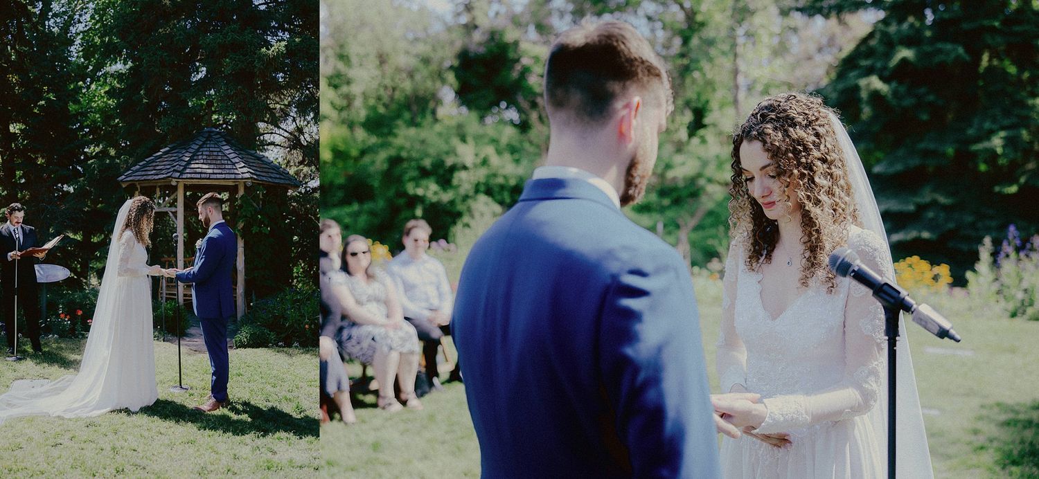Outdoor wedding ceremony with guests watching under tree canopy.