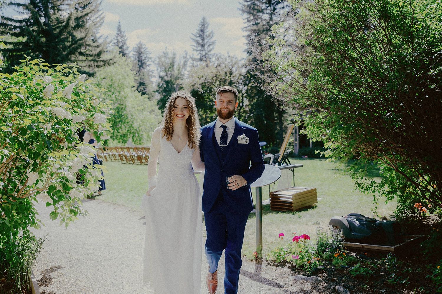 Outdoor wedding ceremony with pine trees and natural scenery in the background.
