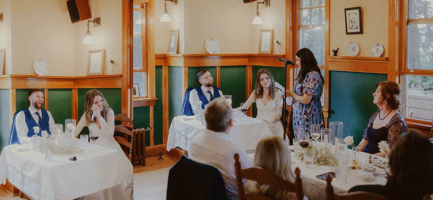 Wedding reception hall filled with guests at tables during a celebration.