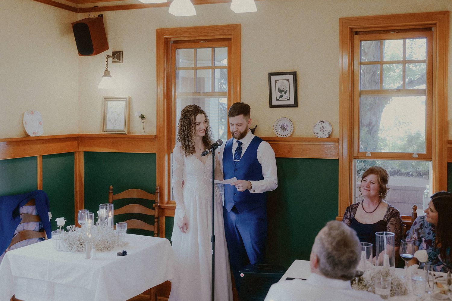 Indoor wedding reception venue with wooden trim and classic dining setup.