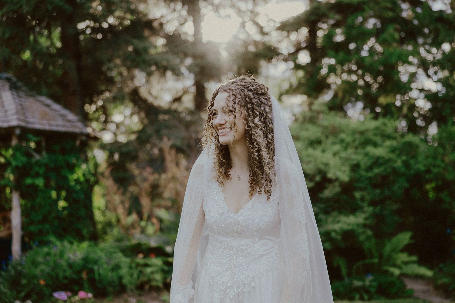 Wedding ceremony setup in a lush garden setting with natural greenery backdrop.