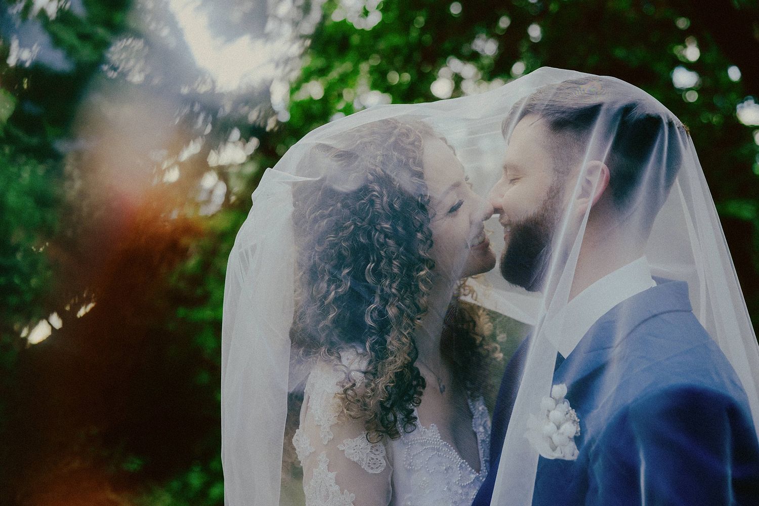 Romantic outdoor wedding portraits captured in a dreamy garden setting with natural light.