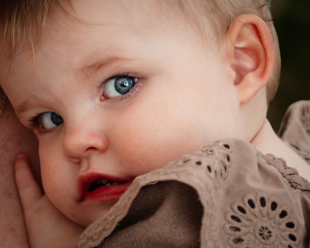 A close-up series of photos showing a baby's face with different expressions and angles.