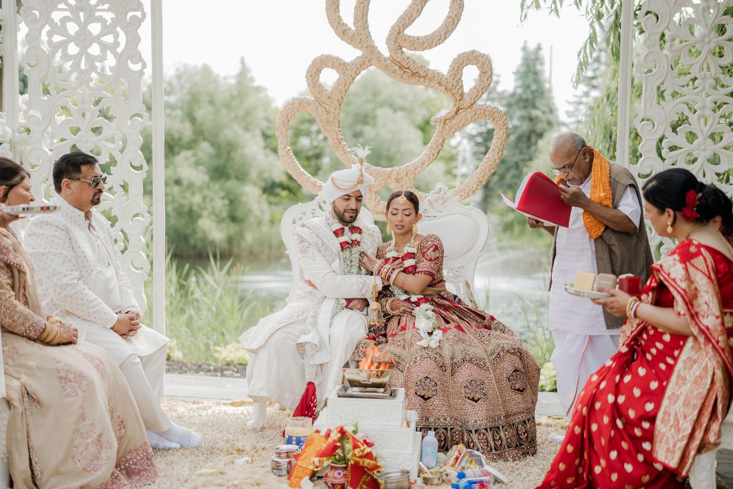 Traditional Indian wedding ceremony with colorful decorations and floral arrangements under an ornate mandap.