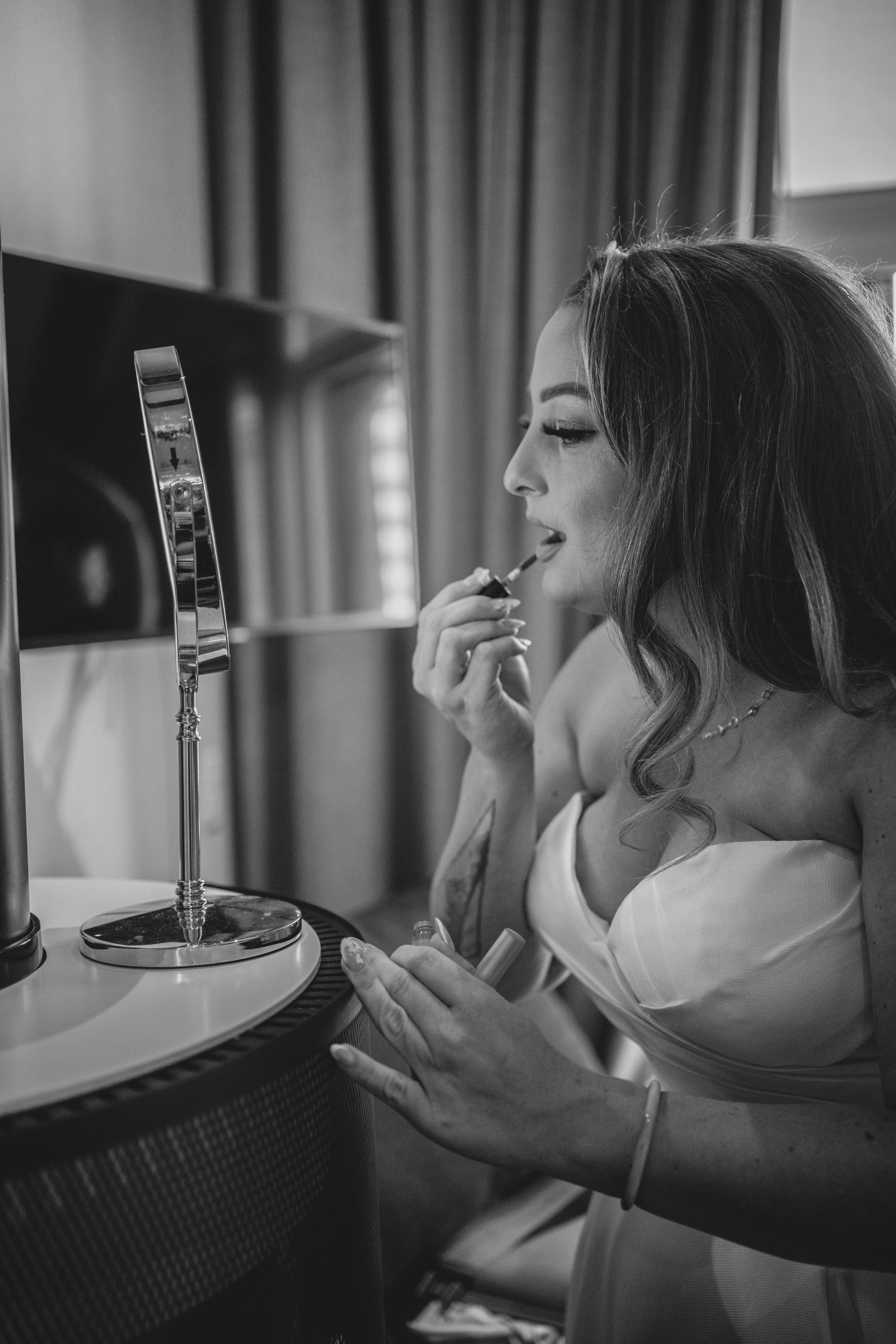 Black and white photo sequence showing someone drinking from a champagne glass in four progressive shots.