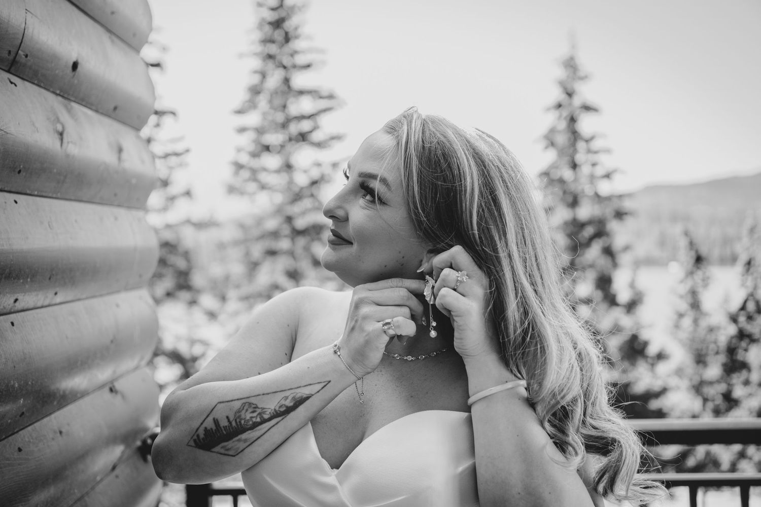 A black and white photo series shows a couple sharing romantic moments on an outdoor deck with mountain scenery.