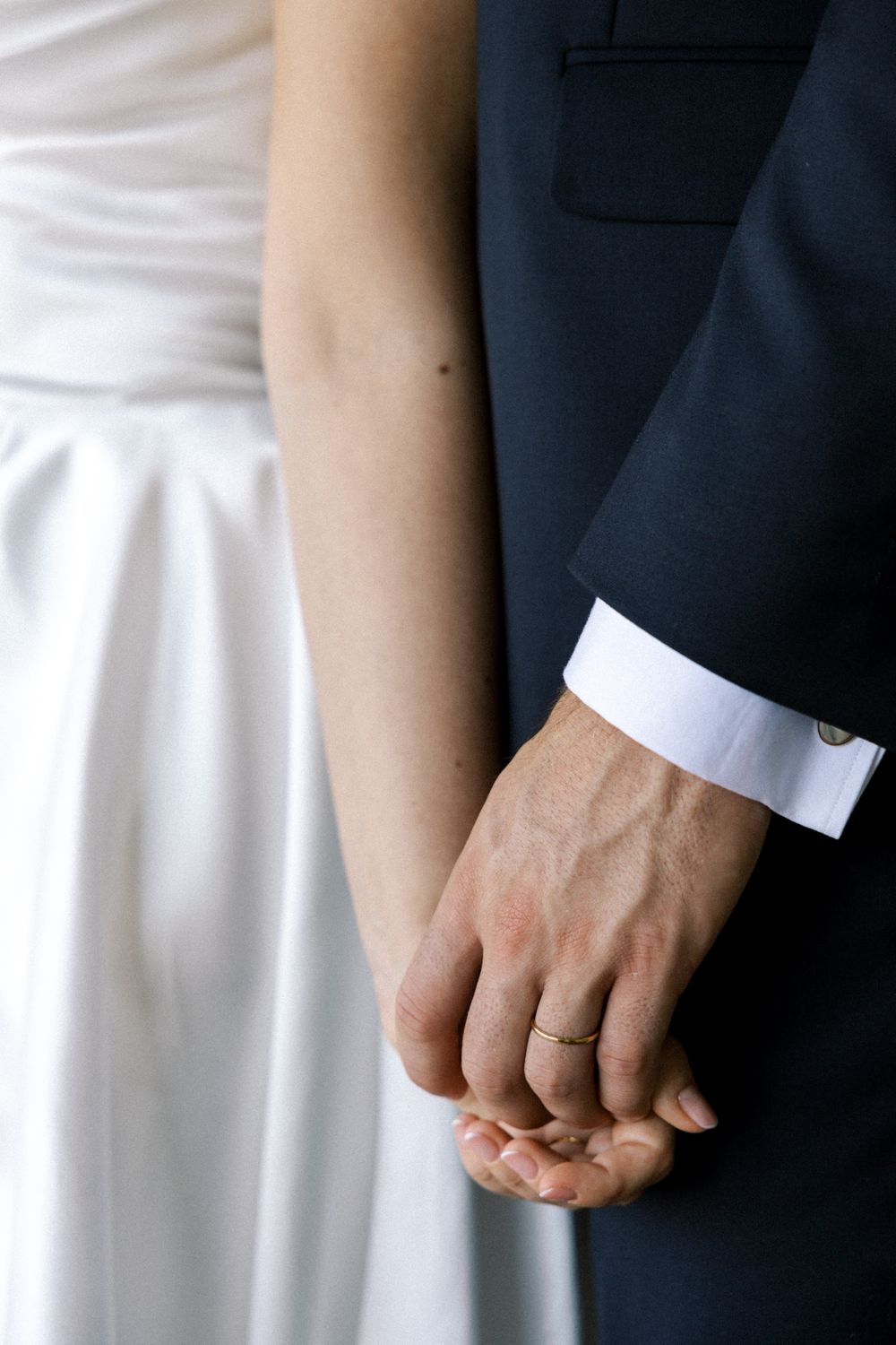 Close-up of bride and groom holding hands during wedding in Portugal