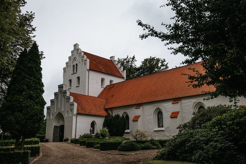 A series of white Danish village churches with traditional red-tiled roofs and stepped gables photographed from different angles.