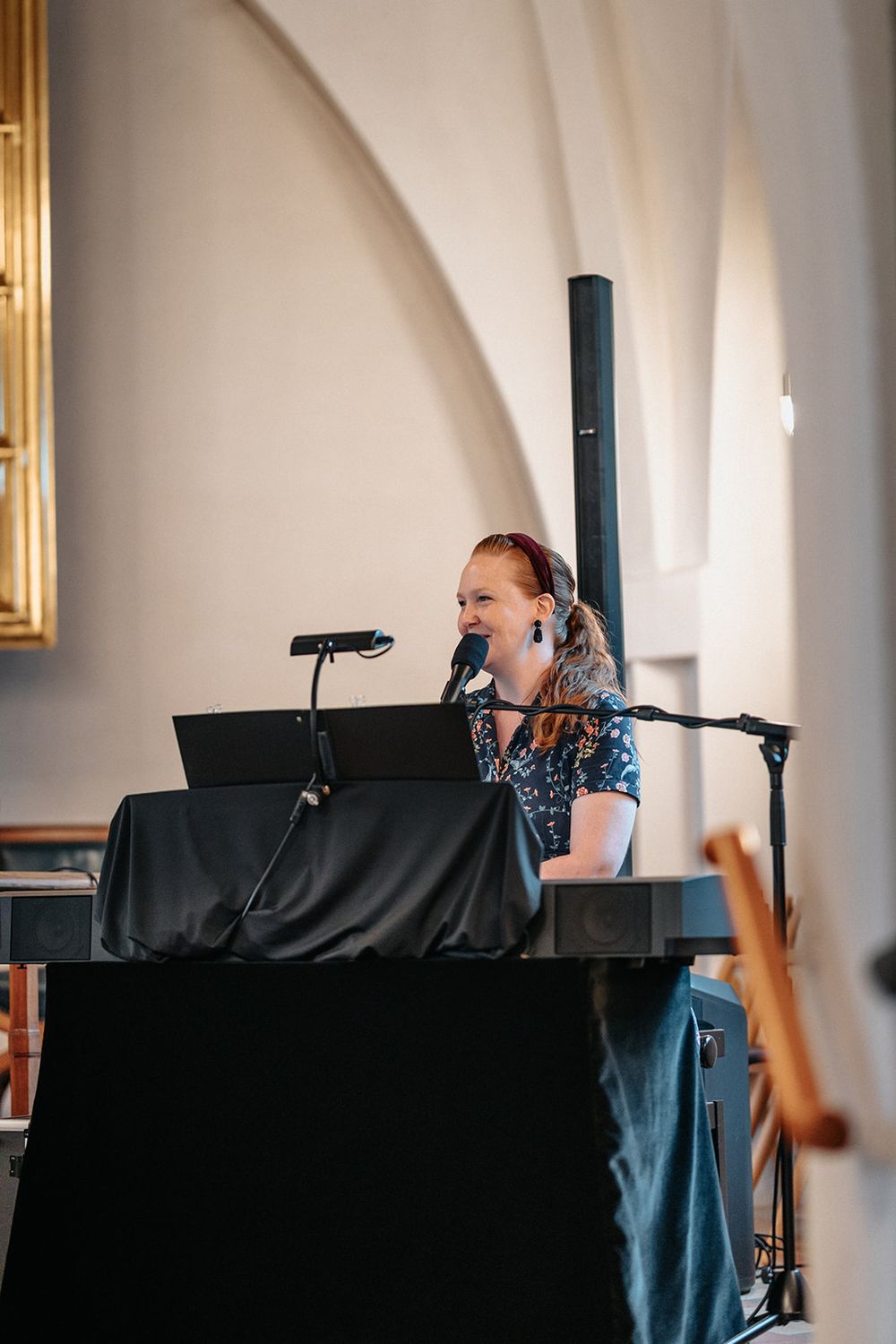 A performer plays piano and sings at a microphone in a series of four candid performance shots.