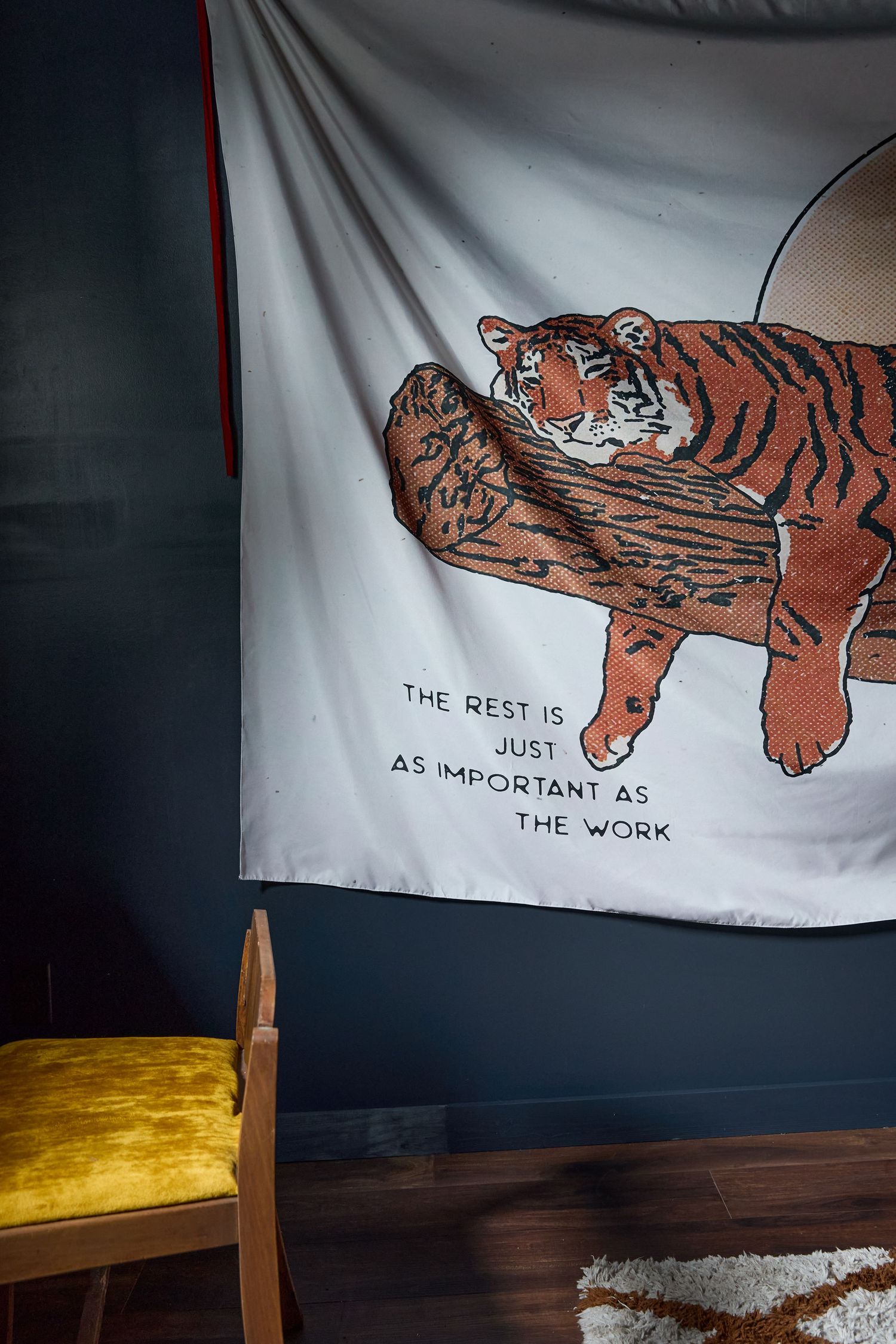 A series of white fabric panels showing a tiger illustration with text that appears to be part of an inspirational message.