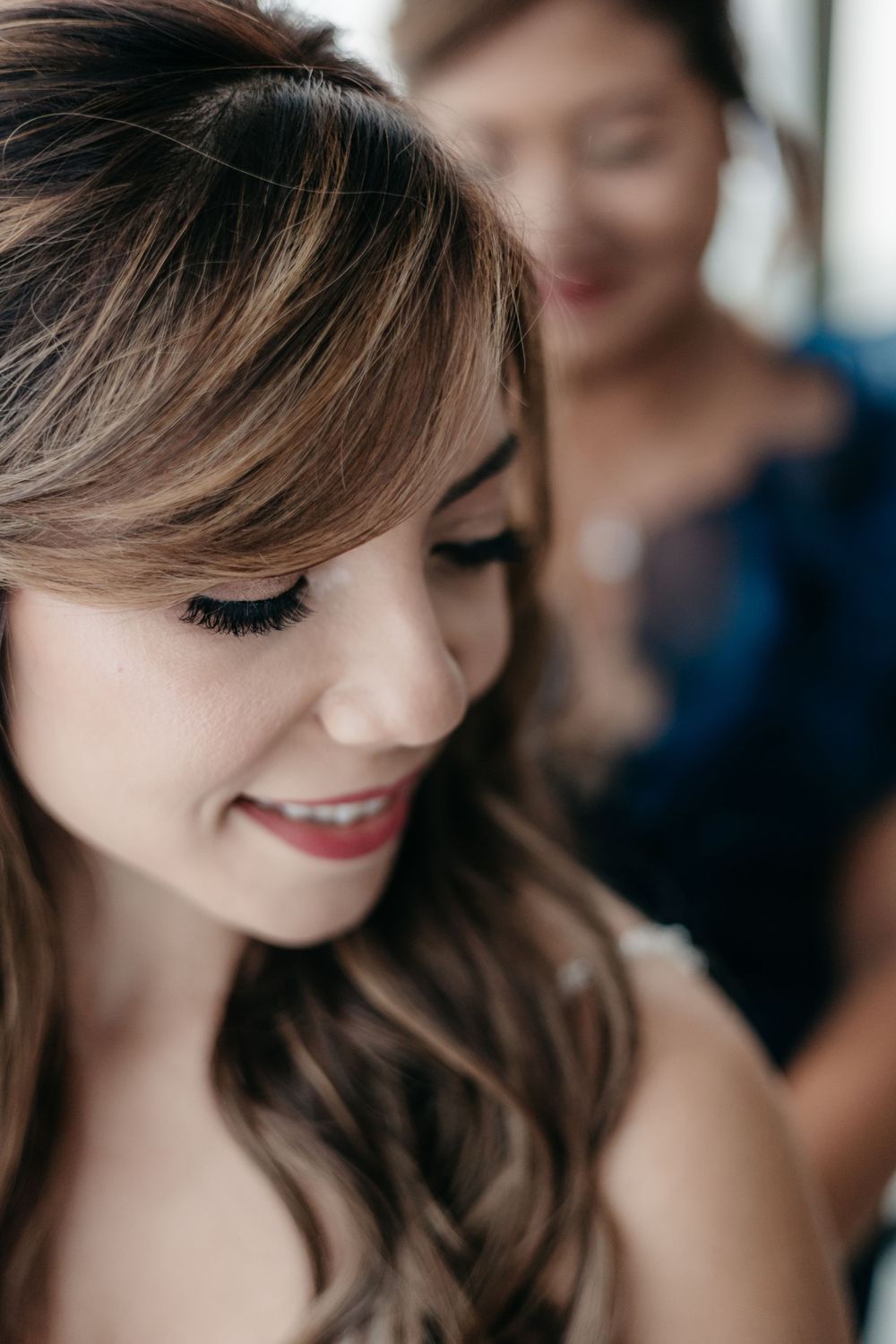 Soft focus beauty portrait showing wavy brown hair and natural makeup.