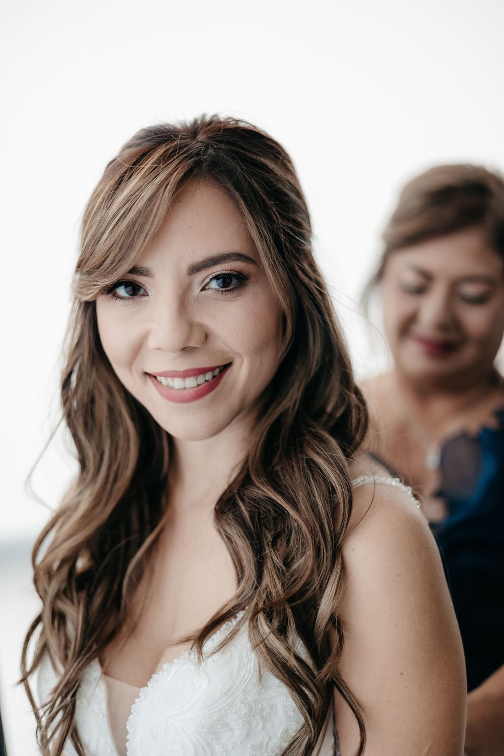 Close-up bridal portraits showing joyful expressions and styled hair.