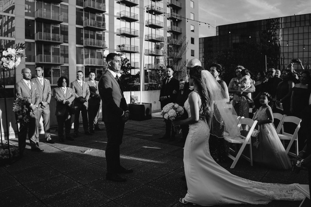 Black and white wedding ceremony photos showing a joyous celebration with guests and decor.