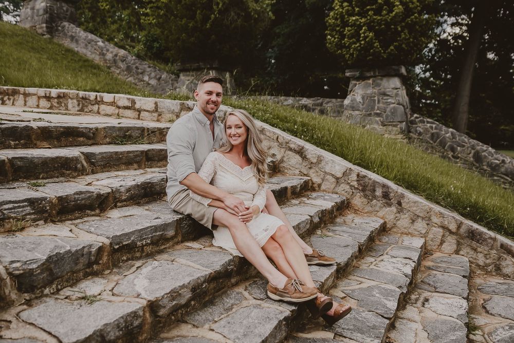 Couple sitting on rustic stone steps outdoors during a photo session in Atlanta, Georgia.