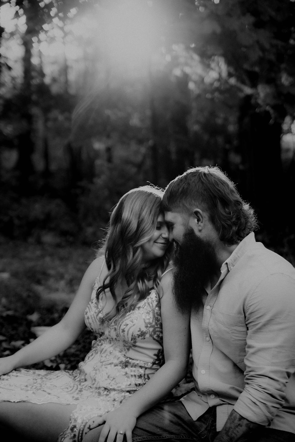 Intimate black and white photo sequence in a forest setting with dramatic backlighting.