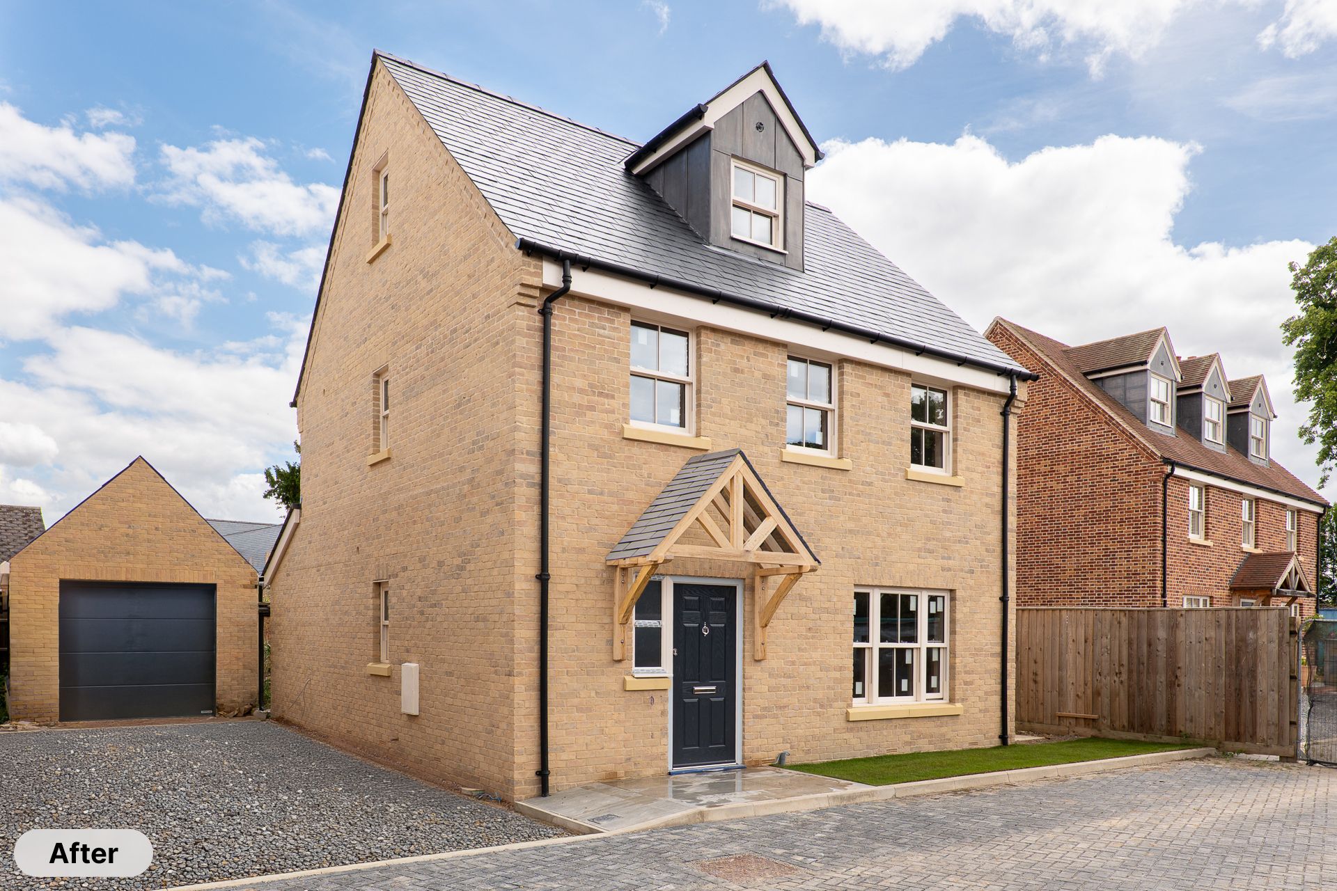 Modern newly built detached house with light brick exterior, slate roof, dormer window, and oak framed porch entrance.