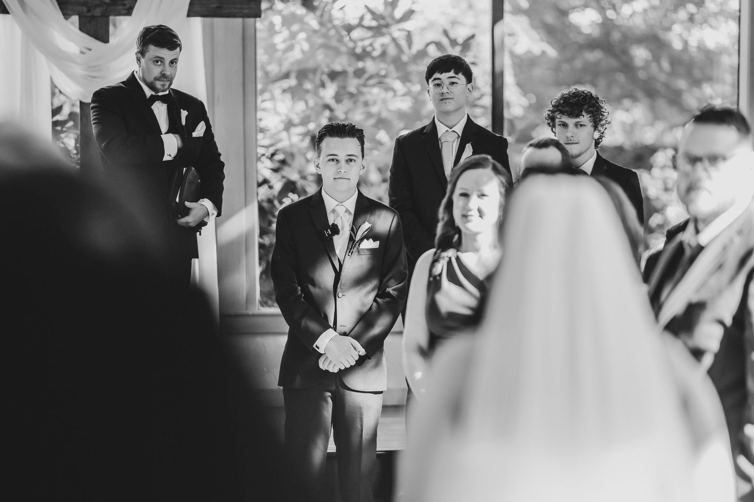 Groom watching his bride walk down the aisle at Brighton Abbey