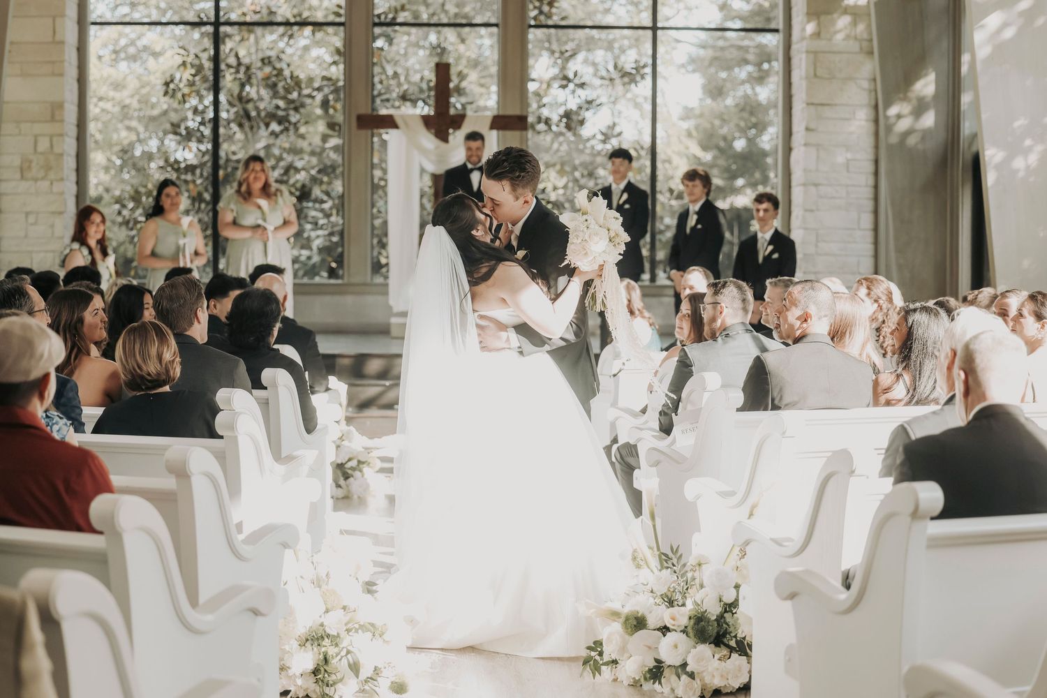 Groom dipping his bride during their wedding recessional