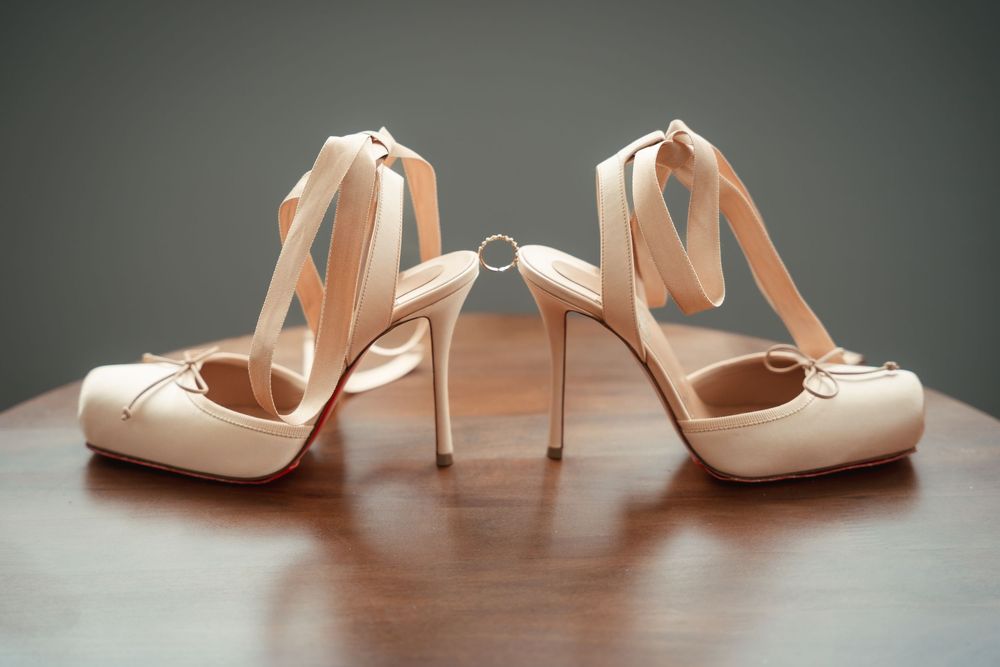 Bridal shoes with ring displayed before the wedding ceremony.