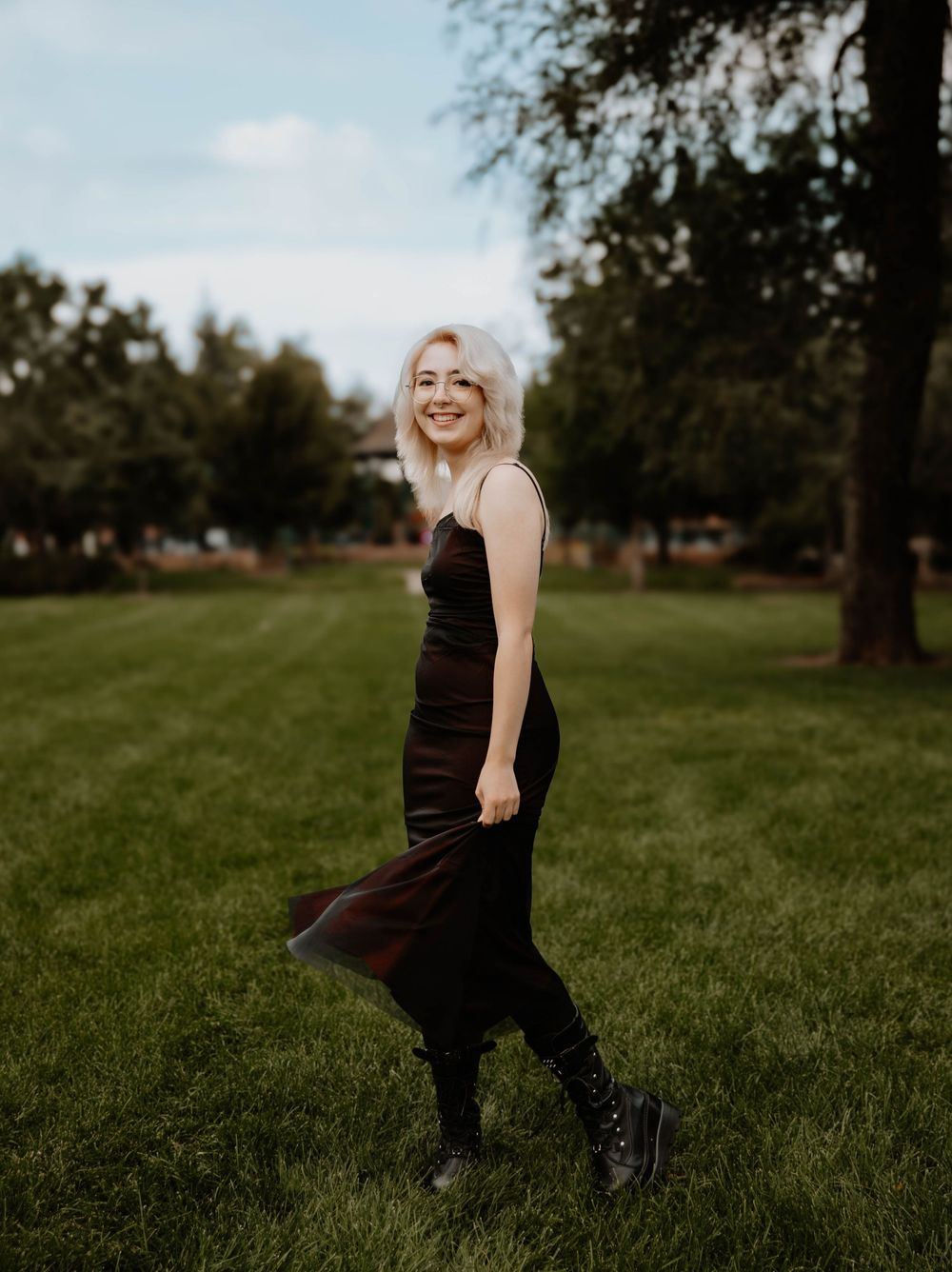 Girl poses swinging her dress for senior photos, cinematic photos, and portraits in Arvada, Colorado outside and in nature photo