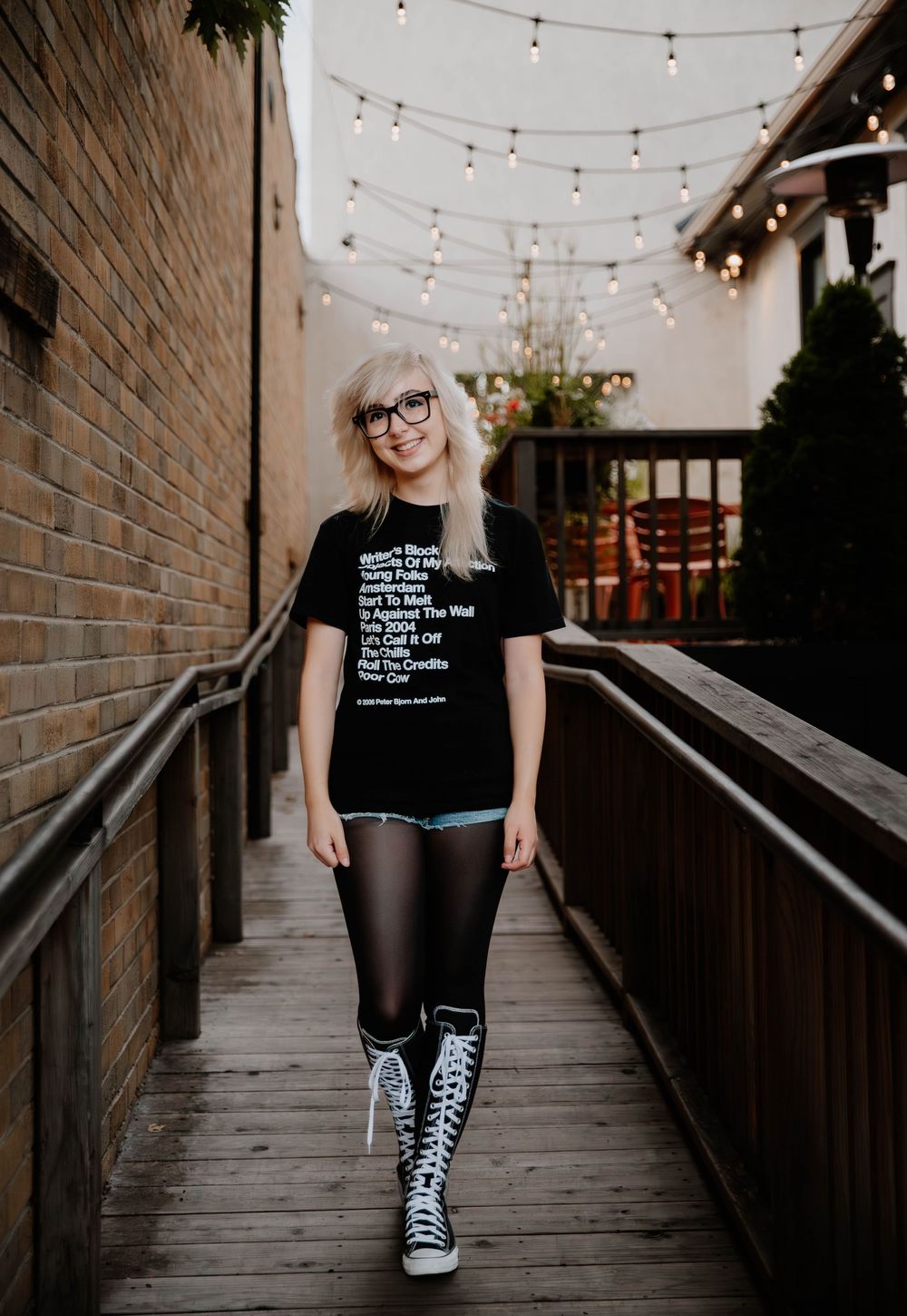 Girl walks down urban alley and poses for senior photos, cinematic photos, and portraits in Arvada, Colorado outside and in nature photo