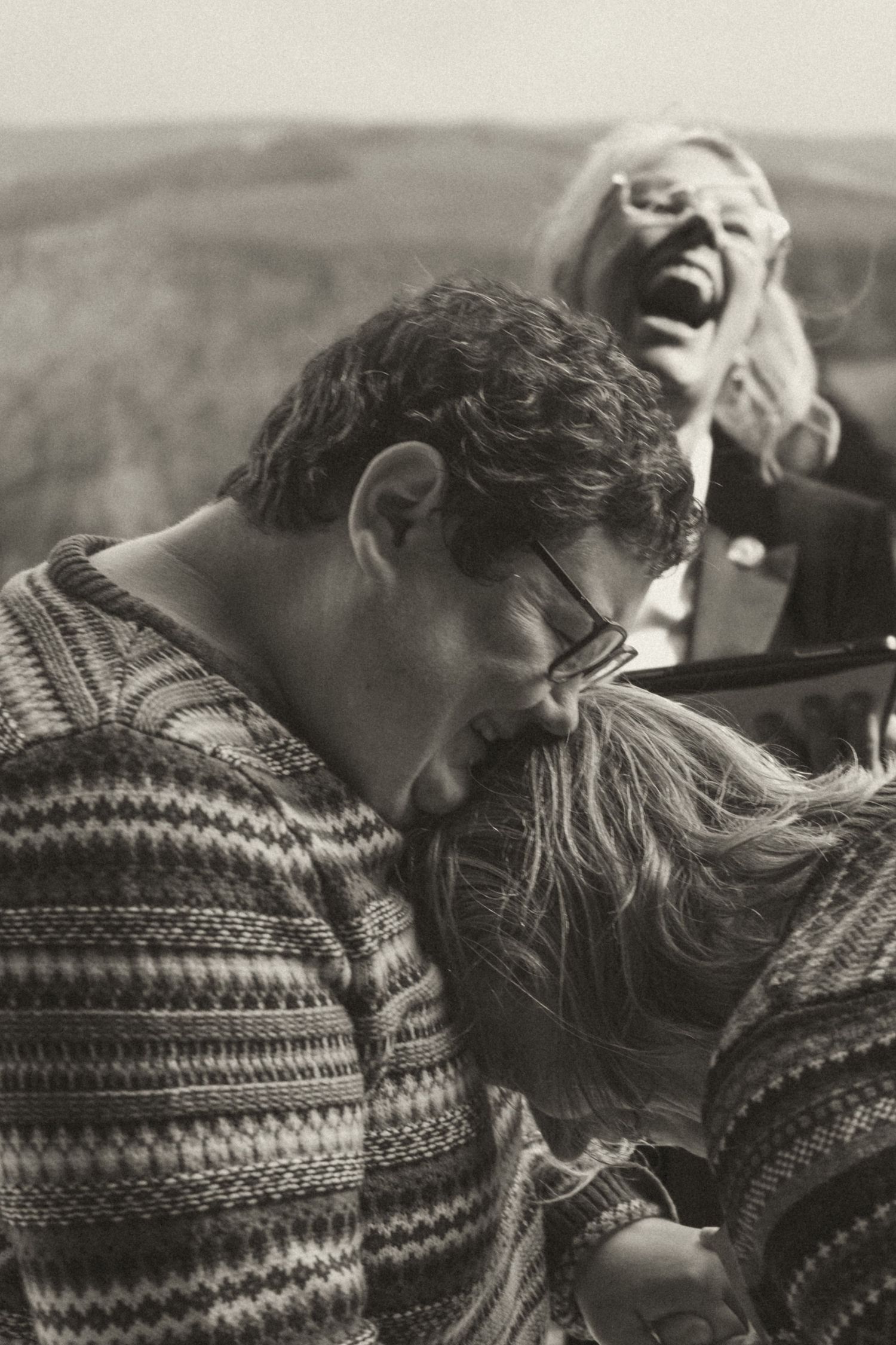 Black and white portrait of a couple laughing together during their intimate Scotland wedding.