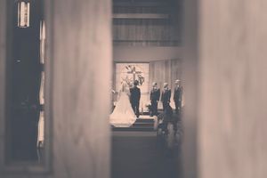 Black and white photo of a bride and groom at the altar during a church wedding ceremony.
