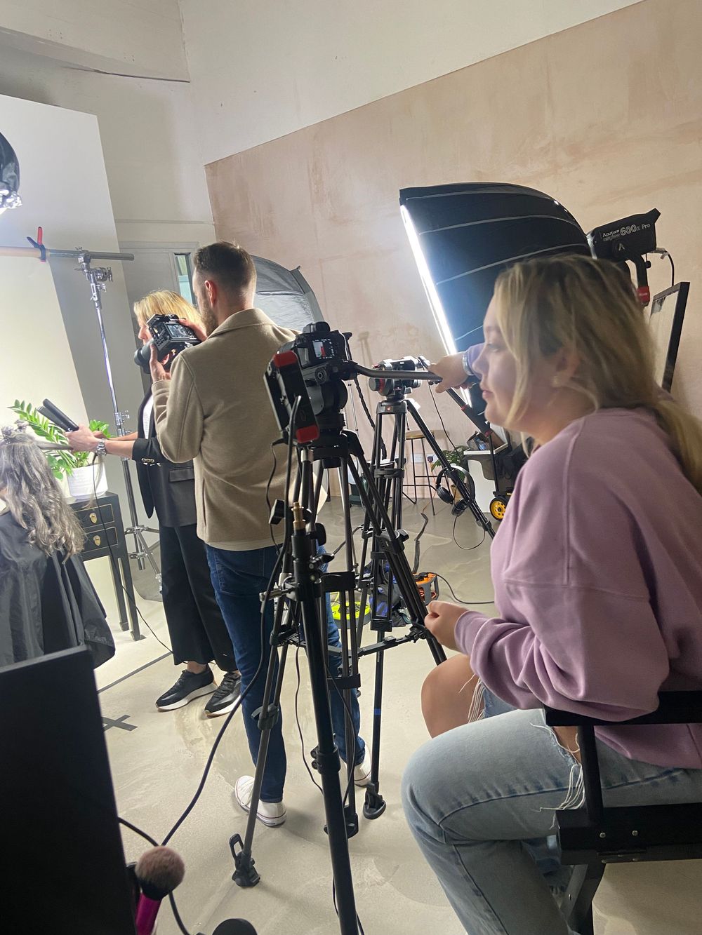 Behind the scenes photo shoot with cameras and lighting equipment.