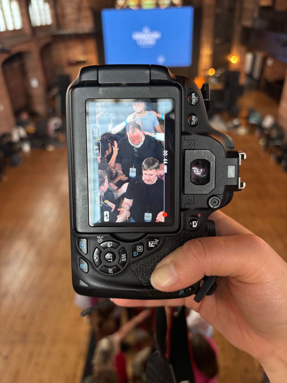 Camera screen showing photo at indoor event venue.