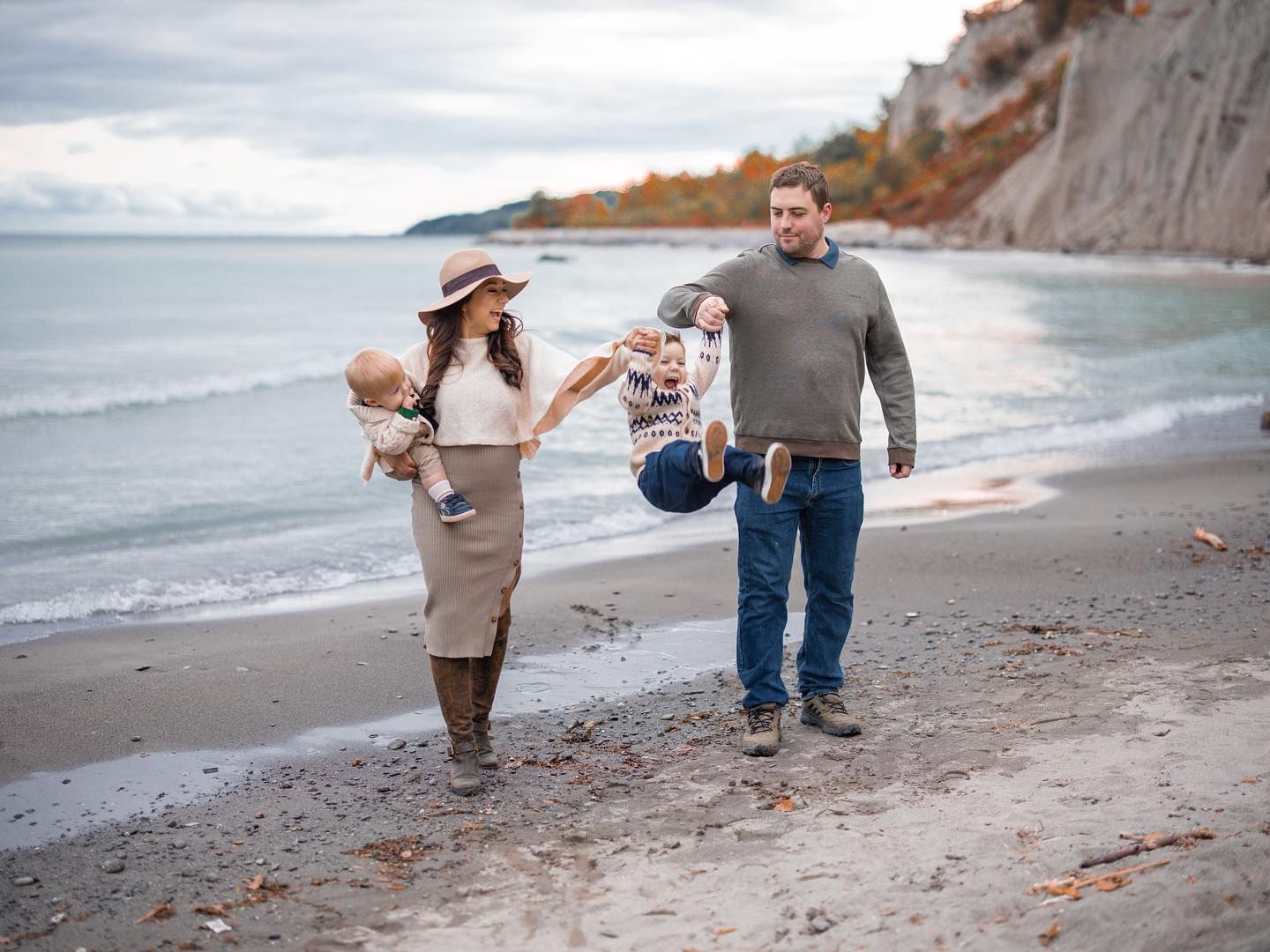 Family walking together on the beach during an outdoor family photo session in Toronto