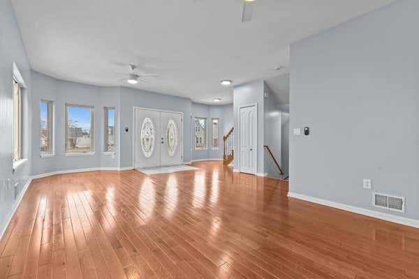 Open living room with hardwood floors and staircase in Dearborn Michigan home