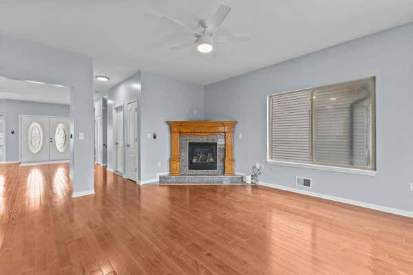 Open living room with hardwood floors and staircase in Dearborn Michigan home