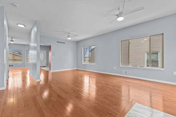 Open living room with hardwood floors and staircase in Dearborn Michigan home