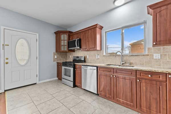 Kitchen with cherry wood cabinets granite counters and stainless appliances in Dearborn Michigan