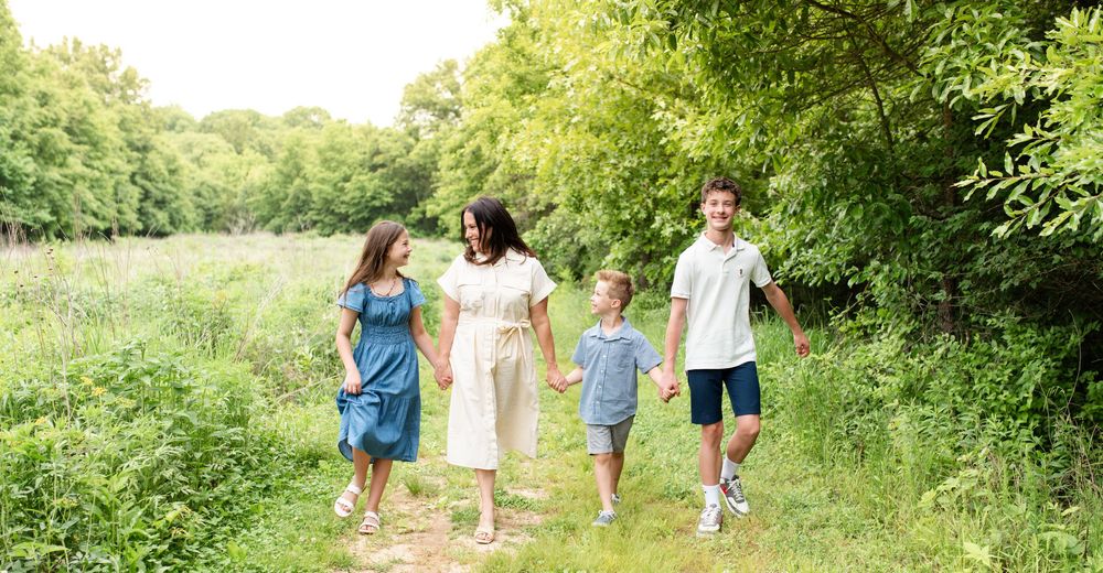 Family laughing during outdoor photos in O’Fallon Missouri