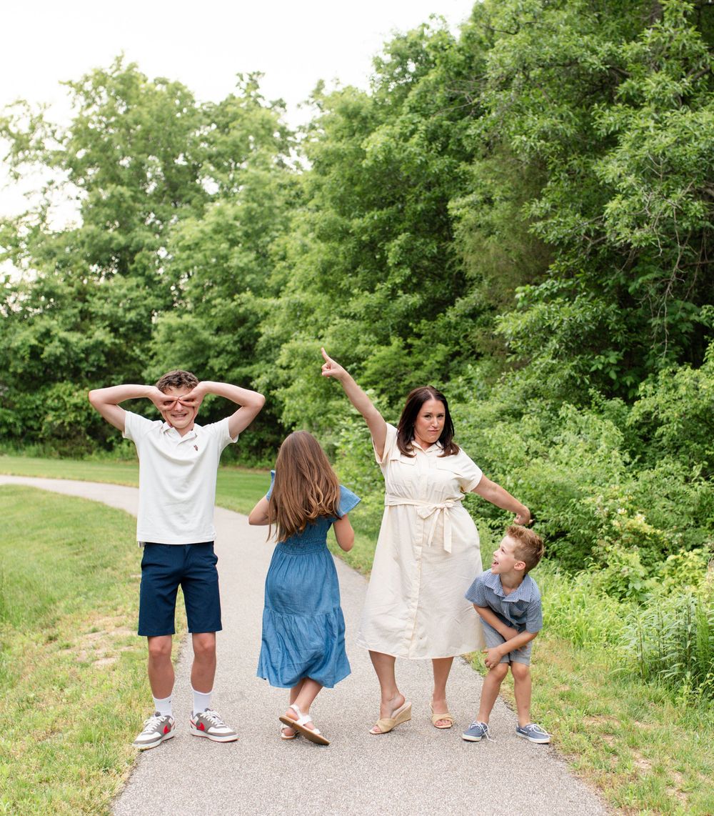 Family laughing during natural light photos in O’Fallon MO