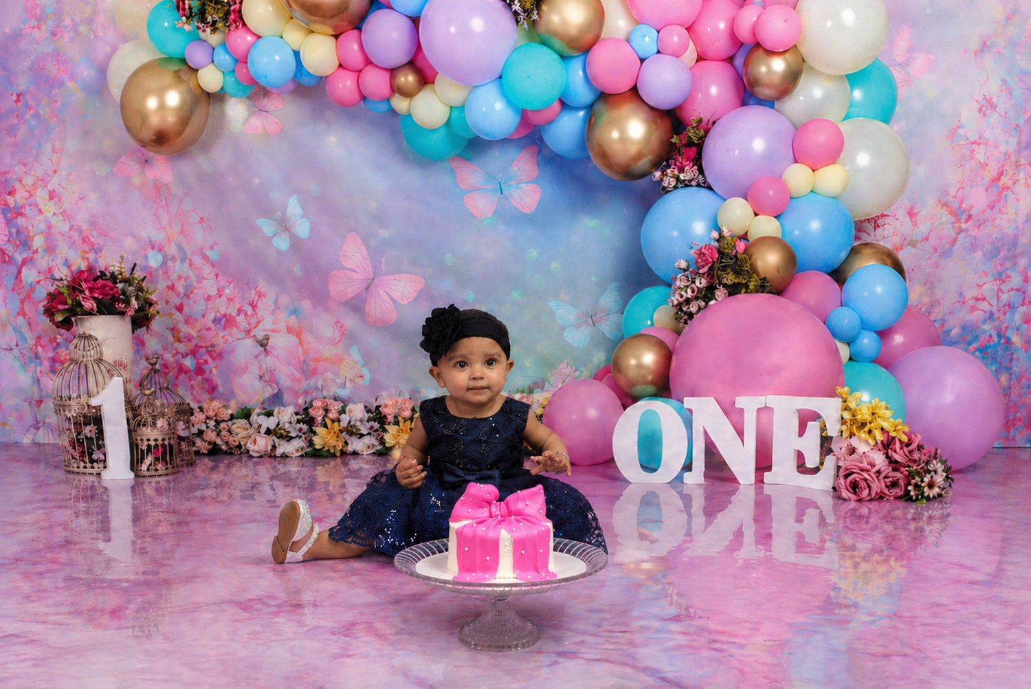 Baby enjoying cake smash during birthday photoshoot