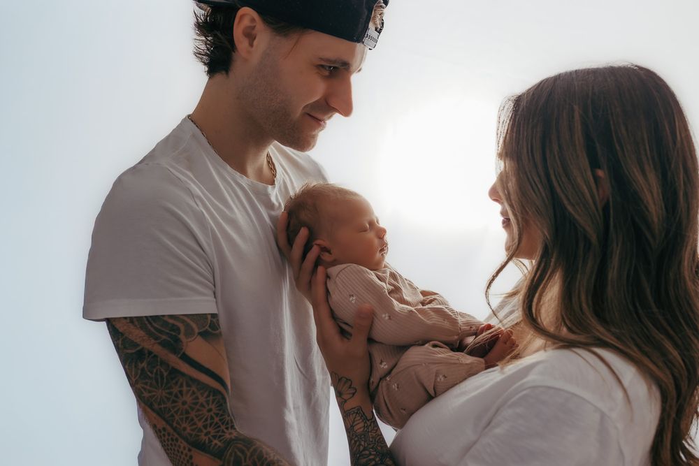 Close up shot of mom and cuddling their newborn during their studio photos.