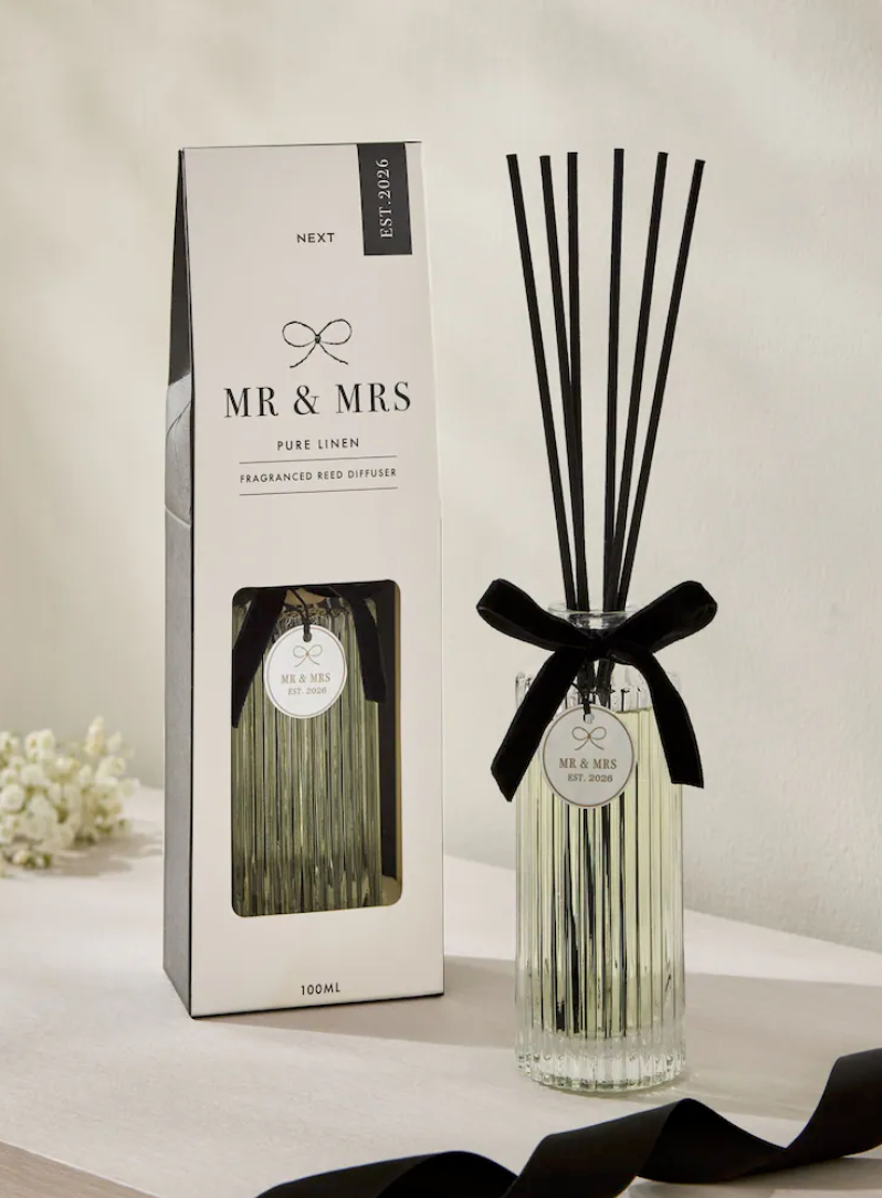 Mr & Mrs Pure Linen fragranced reed diffuser 100ml with black ribbon and reeds, displayed next to its elegant white box.