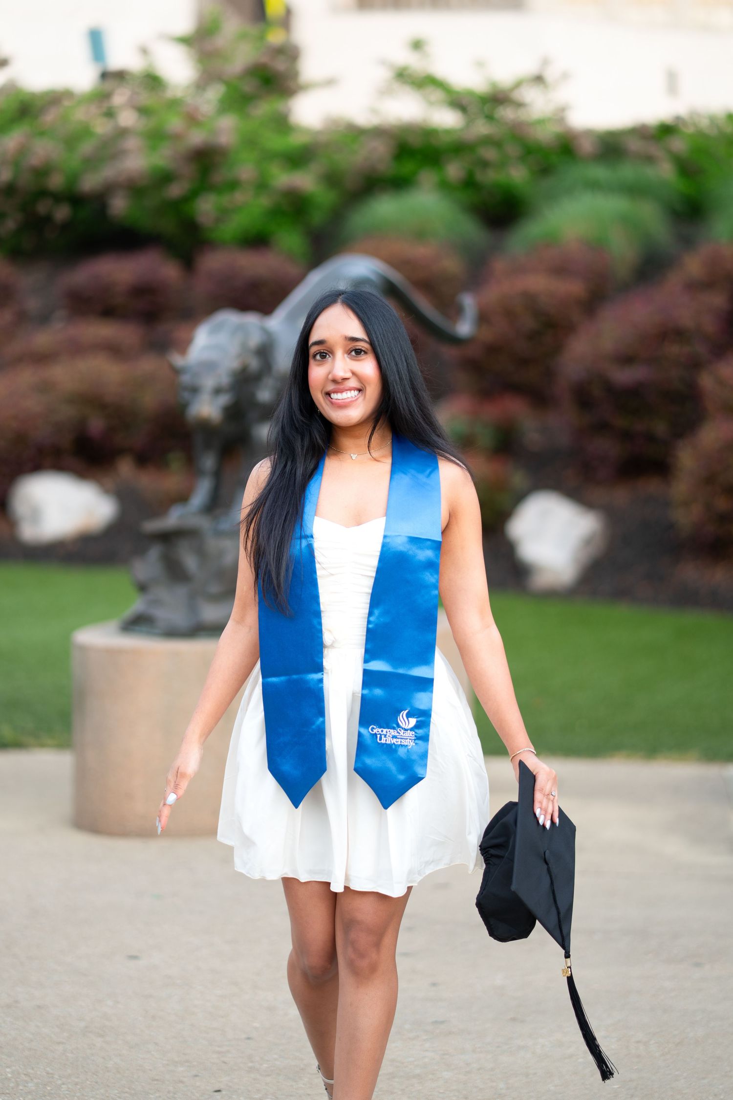 Smiling graduate poses for the best Atlanta grad photos at Georgia State University with portraits by Pierre The Pear Photography