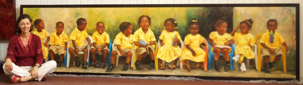 Woman sitting beside a large panoramic painting of children in yellow uniforms seated in a row.