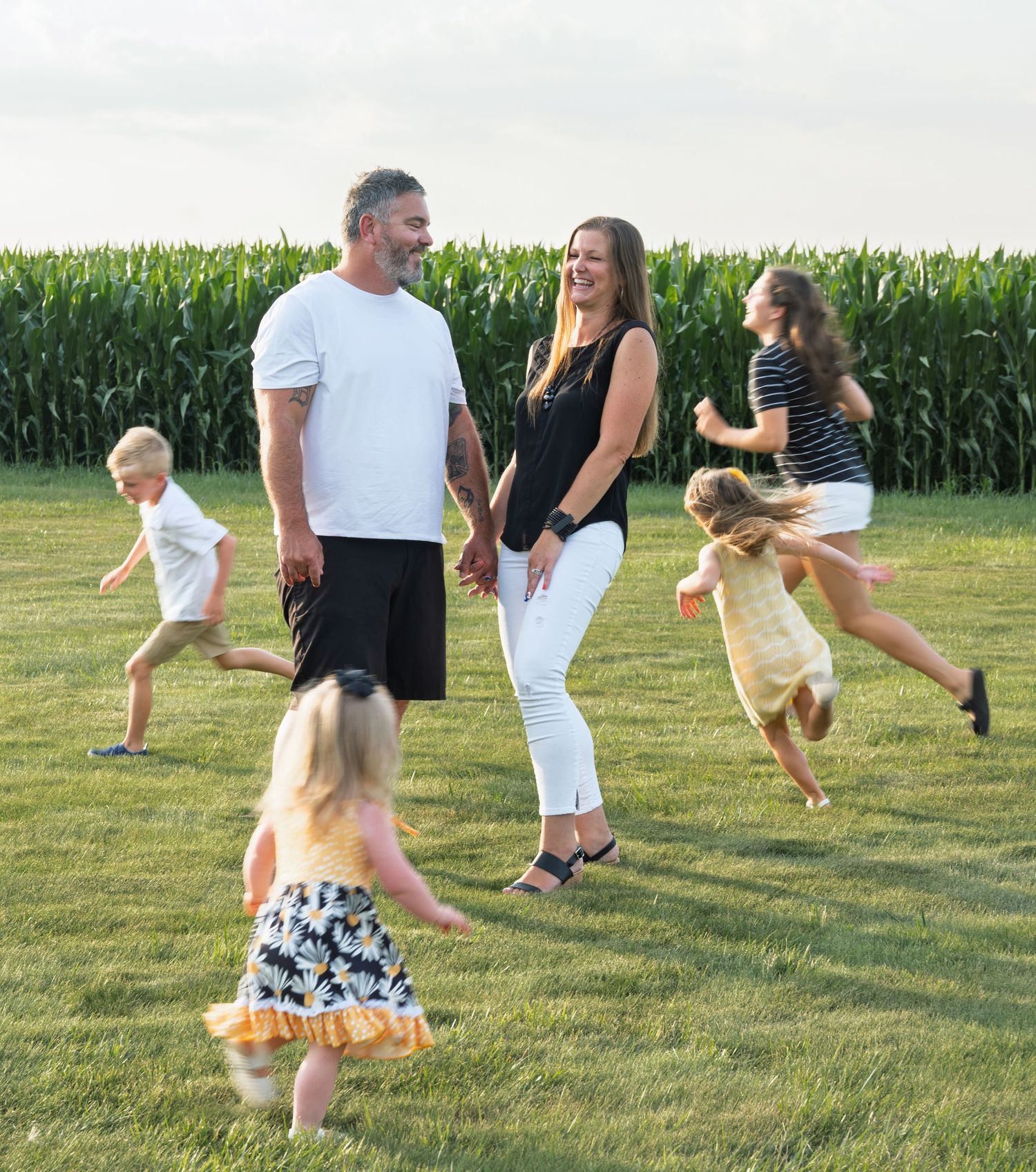 A family under a flower arch.