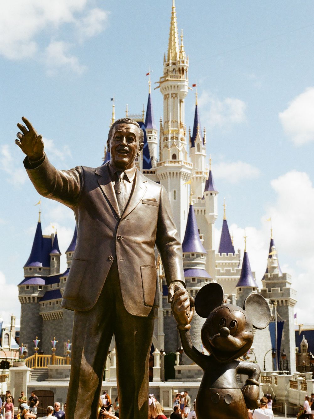 Bronze Partners statue of Walt Disney and Mickey Mouse in front of Cinderella Castle at Magic Kingdom Disney World.