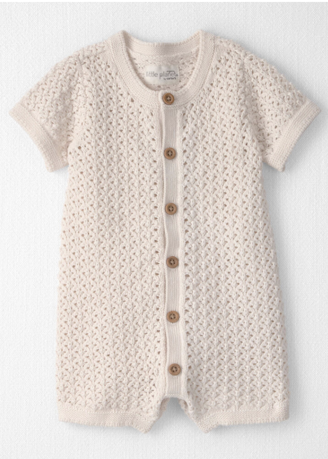 Cream knit baby romper with short sleeves, button front, and open-weave texture pattern.
